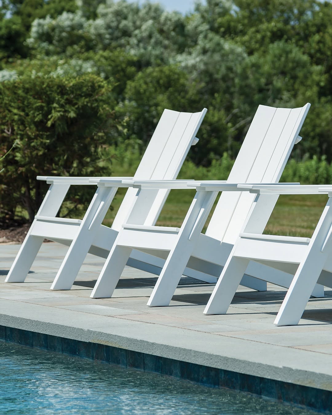 Clean lines. Bright finish. Timeless outdoor comfort.

Our MADirondack Chairs in White bring a fresh, modern perspective to a classic, creating a relaxed poolside setting designed for long afternoons outdoors.

Crafted from durable EnviroWood, each piece is made to withstand the elements while maintaining its crisp appearance season after season.

#OutdoorLiving #PoolsideLounge #EnviroWood #FurnitureDesign